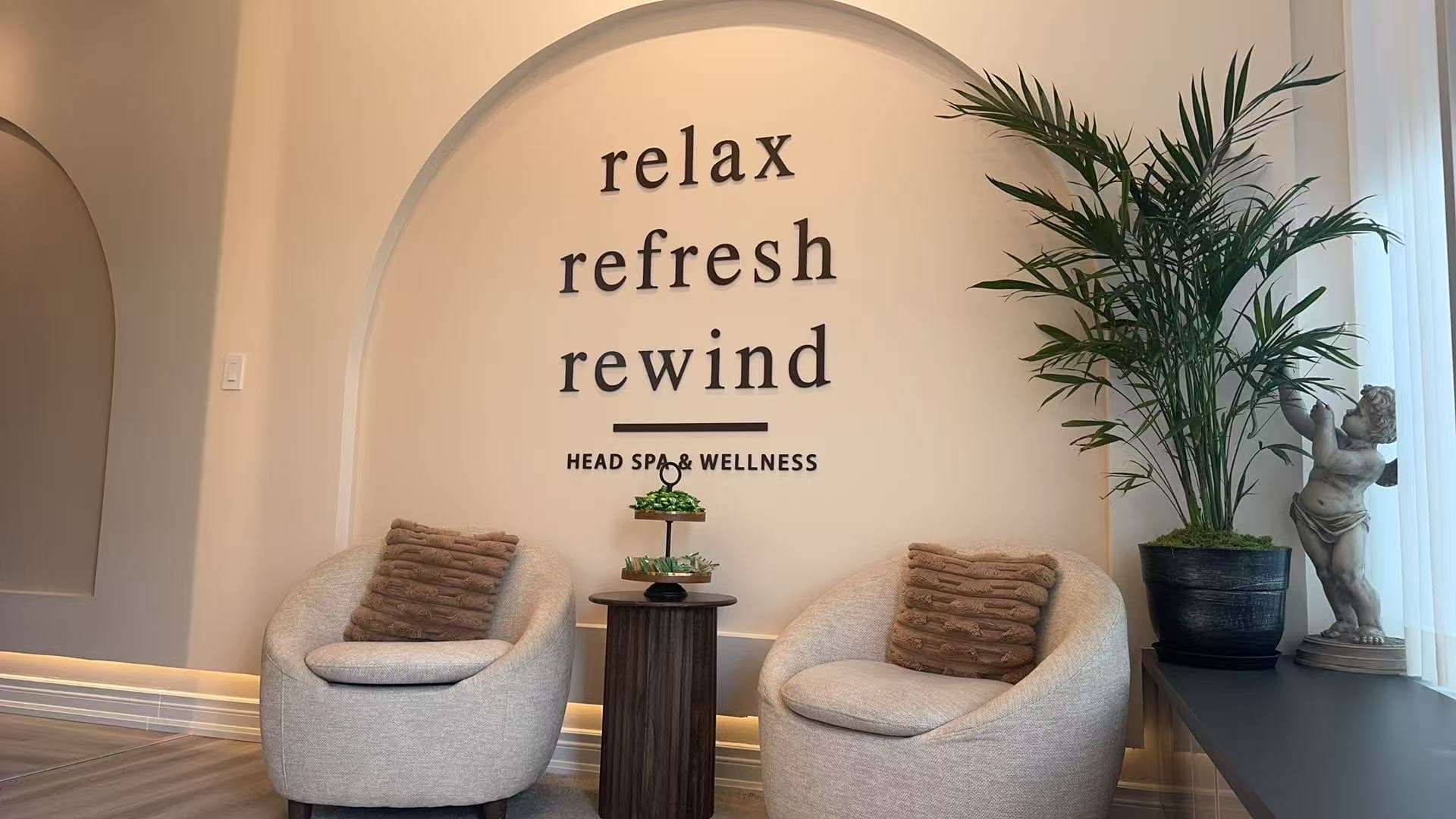 Perfect Head Spa reception — warm, arched, brass-accented interior